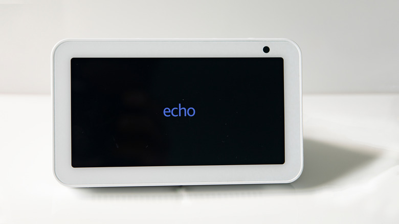 an Amazon Echo sitting on a white table