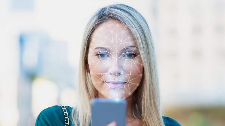 A woman's face being scanned by a phone's front camera