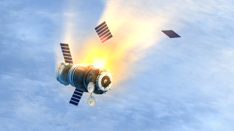 A satellite falling back to Earth, burning up in the atmosphere.