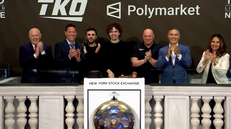 Polymarket CEO Shayne Coplan (center) smiles as he rings the opening bell of the New York Stock Exchange with UFC executives