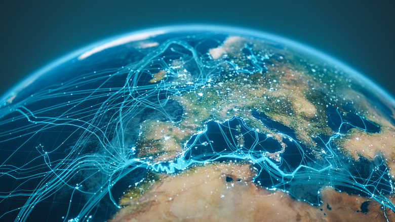 A digital Earth globe showing undersea internet cables running between countries. Not a real representation of cable placement.