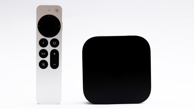 Apple TV 4K (3rd generation) with its remote against a white background