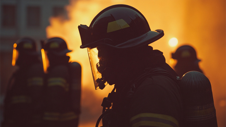 A team of firefighters in front of a fire
