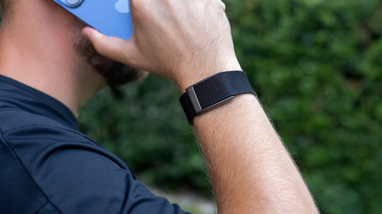 Close up of a man's arm wearing a WHOOP fitness band