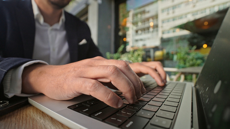 A picture of someone typing on a MacBook