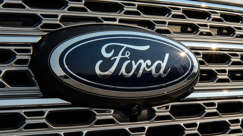 The blue Ford logo on the front grill of an electric vehicle