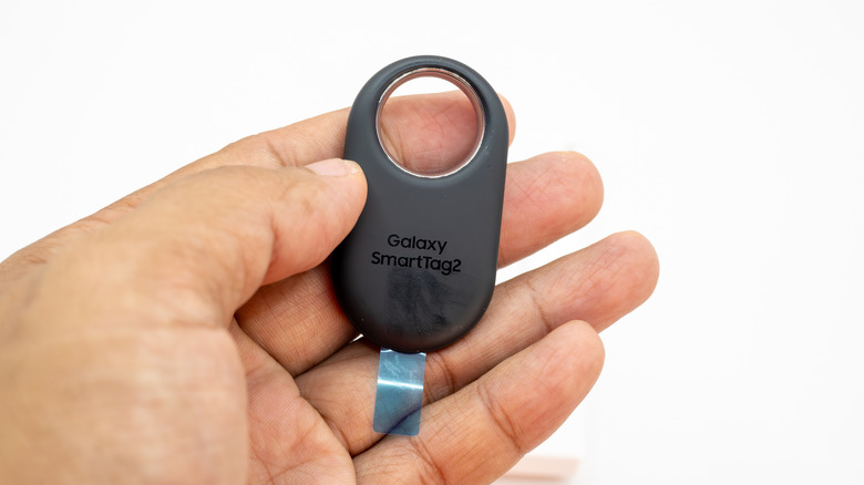Samsung Galaxy SmartTag held in hand with logo visible