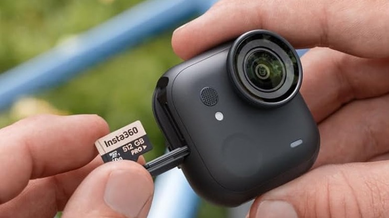 A woman wearing the Insta360 GO Ultra action camera around her neck.