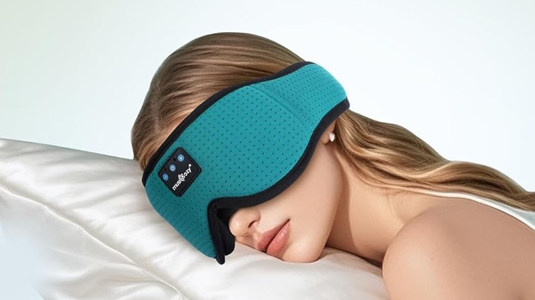 A woman wearing the Musicozy GH01 sleep headphones while she sleeps.