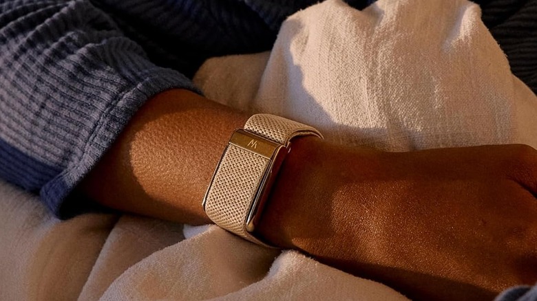 A person wearing the Whoop 5.0 activity tracker on their wrist.