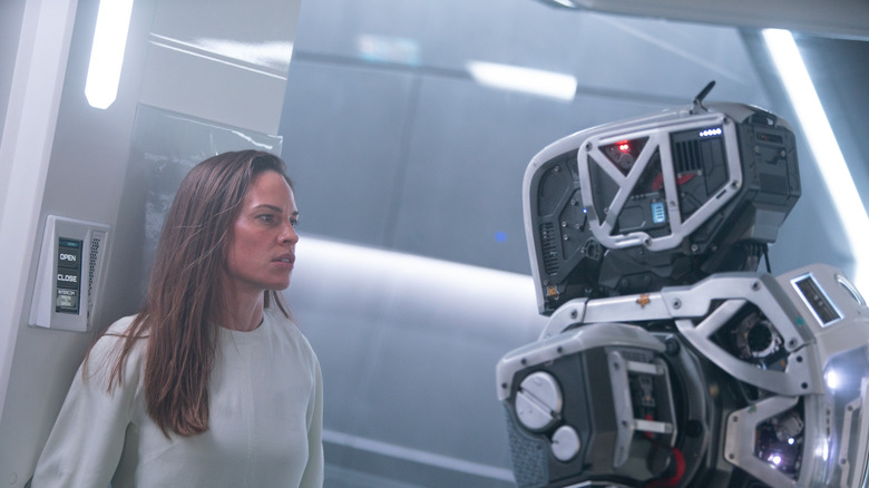 Daughter staring at the robot Mother in the movie "I Am Mother."