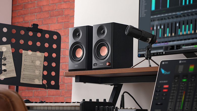 Edifier MR3 active speaker pair on shelf near audio equipment.