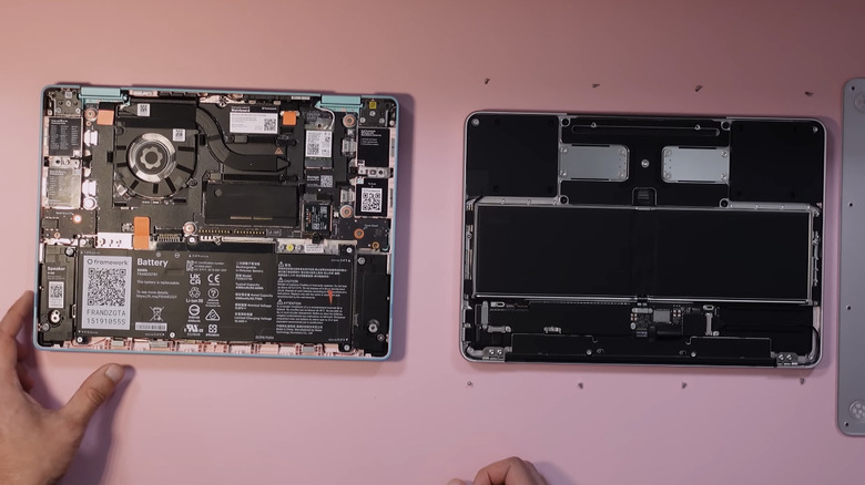 An open MacBook Neo and Framework Laptop 12 placed side by side