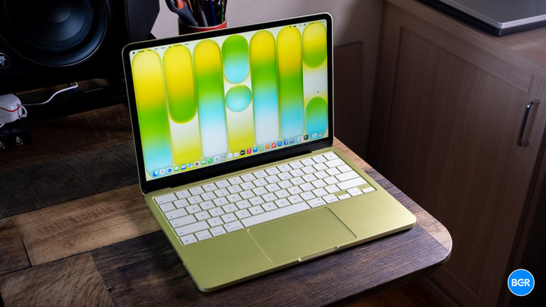 A Citrus MacBook Neo on a wooden table