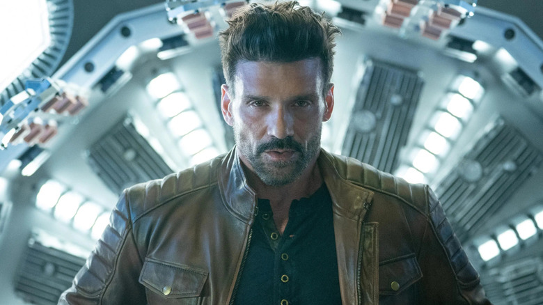 Roy (Frank Grillo) standing in front of a machine in 