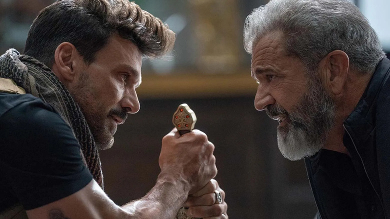Roy (Frank Grillo) and Clive (Mel Gibson) looking at each other in "Boss Level."