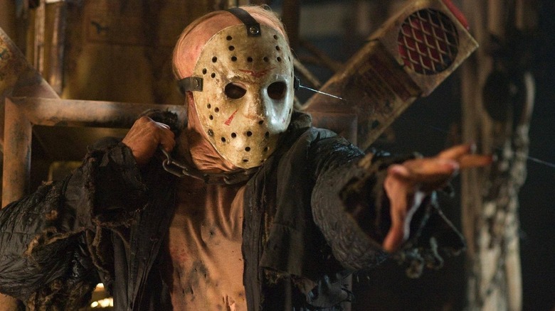 Jason Vorhees with a chain around his neck reaching with his hand