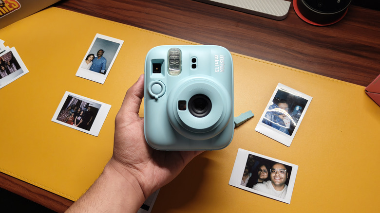A person holding the Instax Mini 13