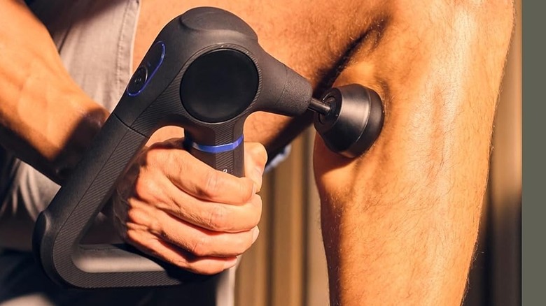 A person using the Theragun Prime (6th Gen) Massage Gun on their legs.