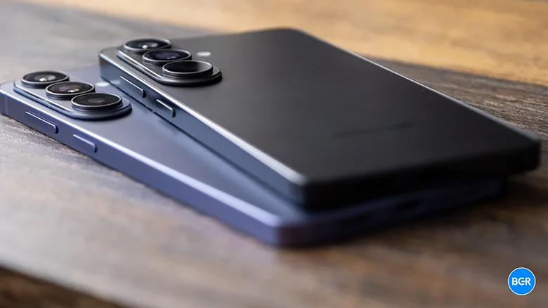 A Samsung Galaxy S26 and S26 Ultra lying atop one another on a table.