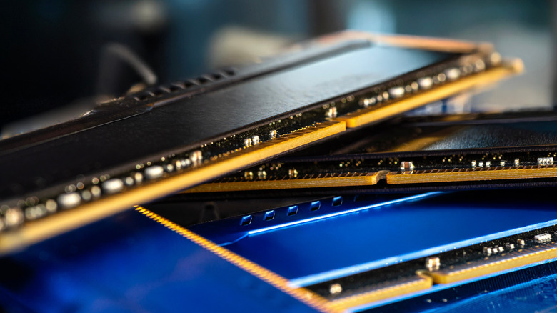 A pile of computer memory modules are stacked haphazardly.