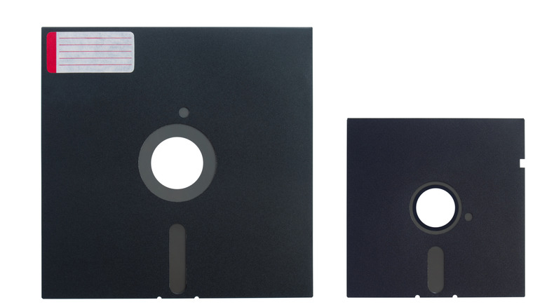 Two floppy disks are shown side by side: an 8-inch floppy disk on the left and a smaller 5.25-inch floppy disk on the right.