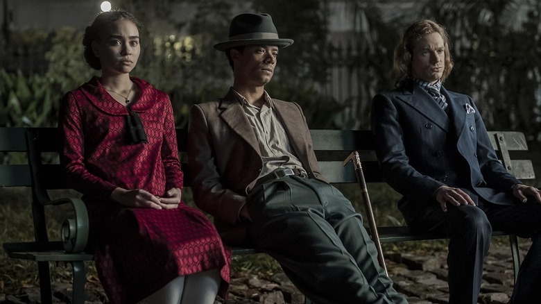 Sam Reid, Jacob Anderson, and Bailey Bass sitting on a bench in Interview with the Vampire