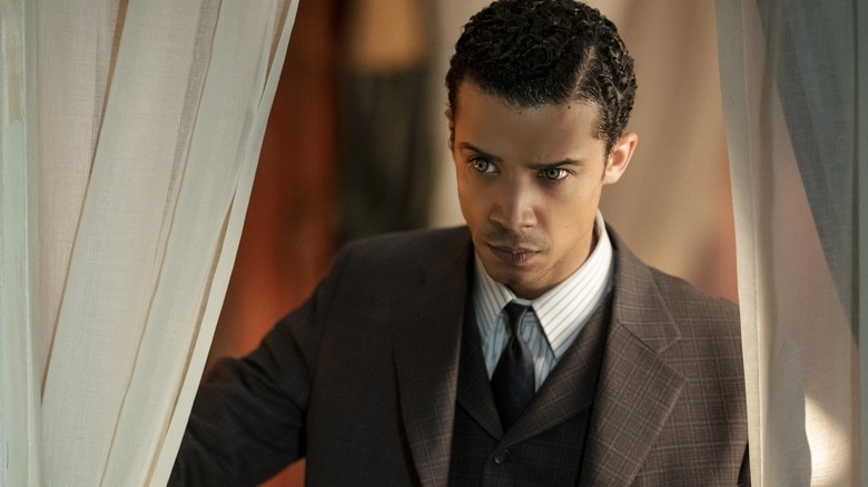 Jacob Anderson as Louis de Pointe du Lac parting a curtain in Interview with the Vampire