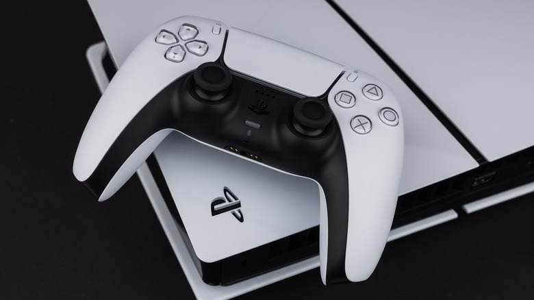 A PS5 and controller displayed against a black background