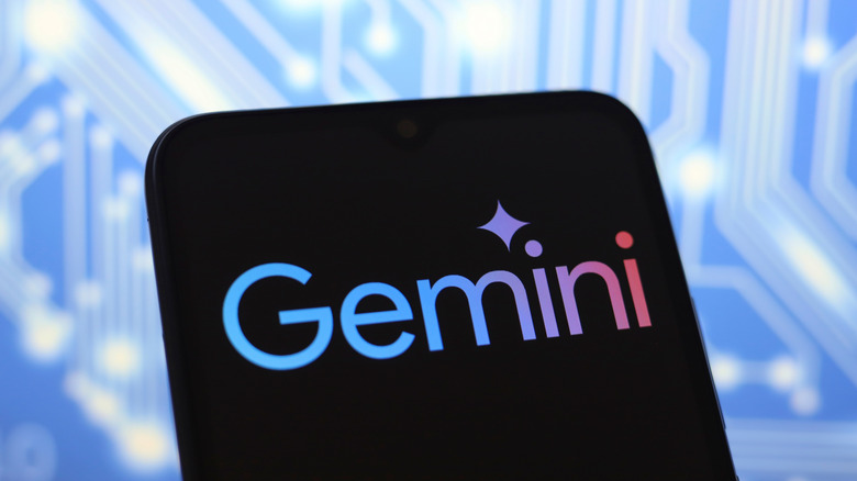 Google Gemini logo on a smartphone in front of a colorful background