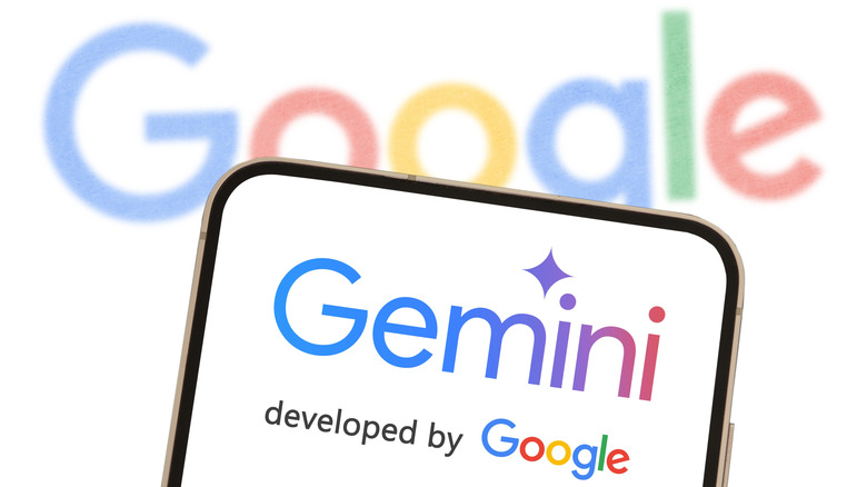 A phone showing the Gemini label in front of a bigger screen displaying Google