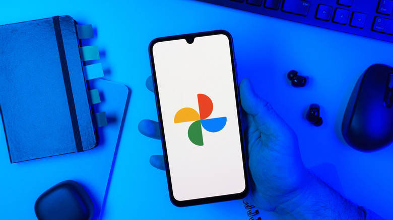 google photos icon on a smartphone with dim, blue background
