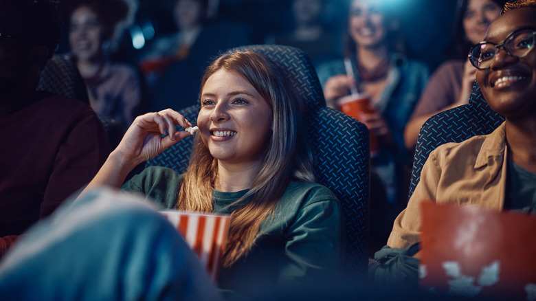 People enjoying popcorn in a movie theater