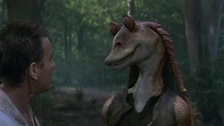 Young Obi-Wan staring at Jar Jar Binks, who is looking back at him.