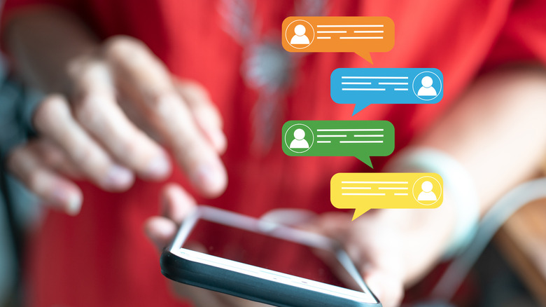 A pair of hands holding an iPhone with four drawings of messages appearing above the device