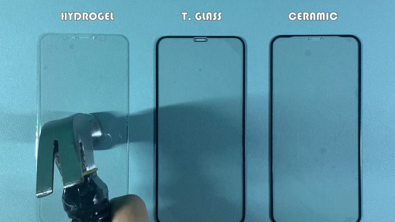 Person hitting a hydrogel phone protector with a hammer.