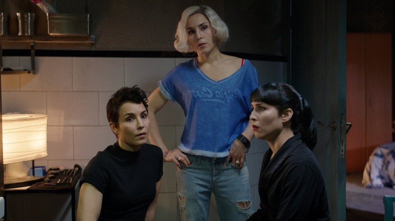 Three of the Settman siblings talking in the kitchen