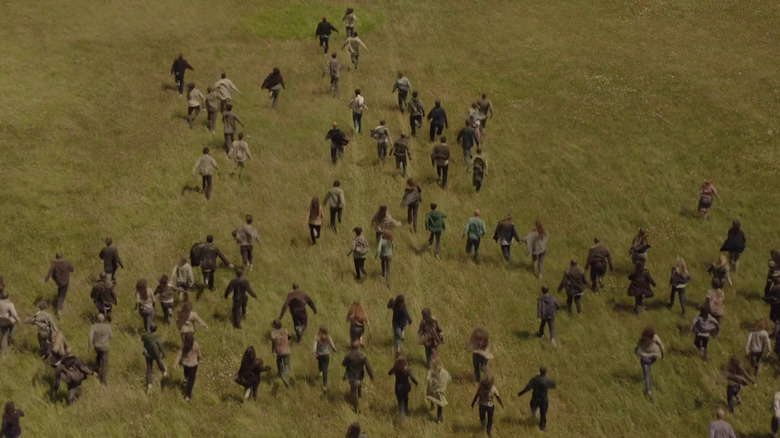 A large horde of hungries running on a field