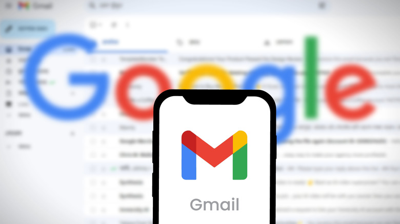 Gmail logo on mobile in front of Gmail for web open on screen in the background.