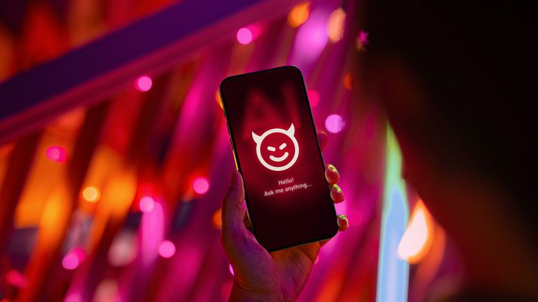 person holding a smartphone with an devilish AI chatbot on it