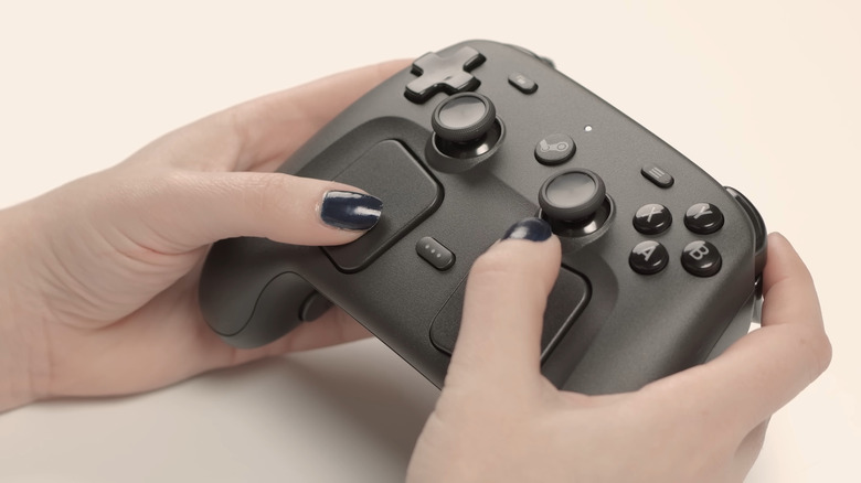 Steam Controller in a users hands as they play.