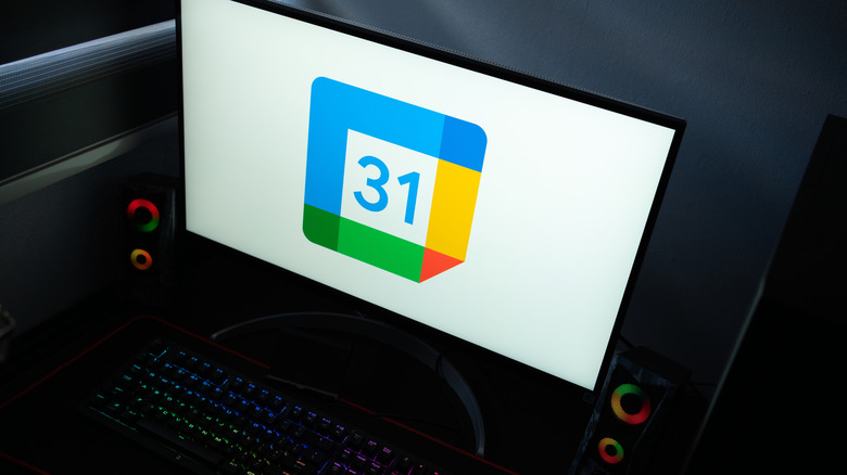 Google Calendar icon on a computer monitor in a dark room