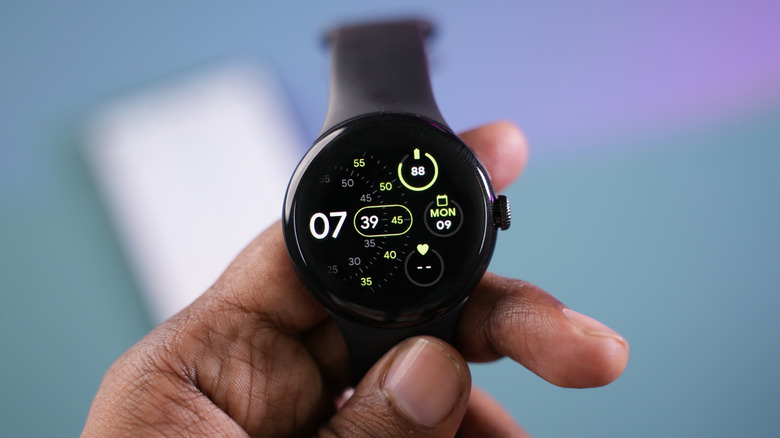 person holding pixel watch in hand