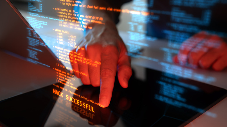 Hacking code overlaid on a display with a person's finger