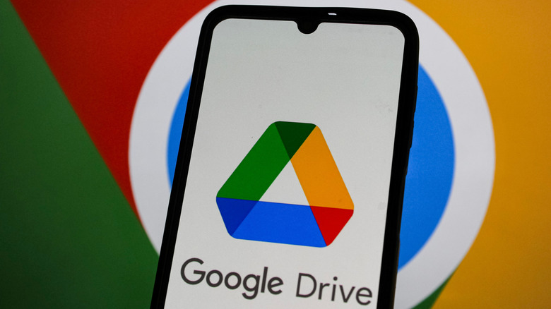 google drive logo on smartphone with larger G logo barely visible in back