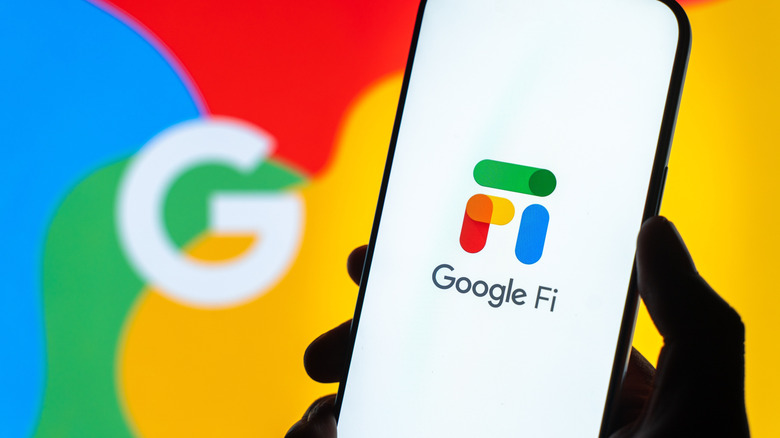 Google Fi Wireless logo on a smartphone display with Google logo in background.