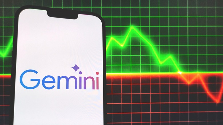 A cellphone displating the Google Gemini logo in front of a mockup of a stock market trend line