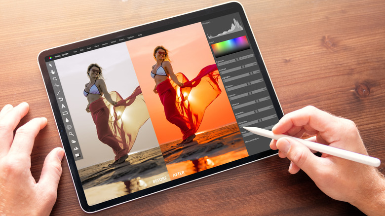 a person editing color on a photo using a tablet
