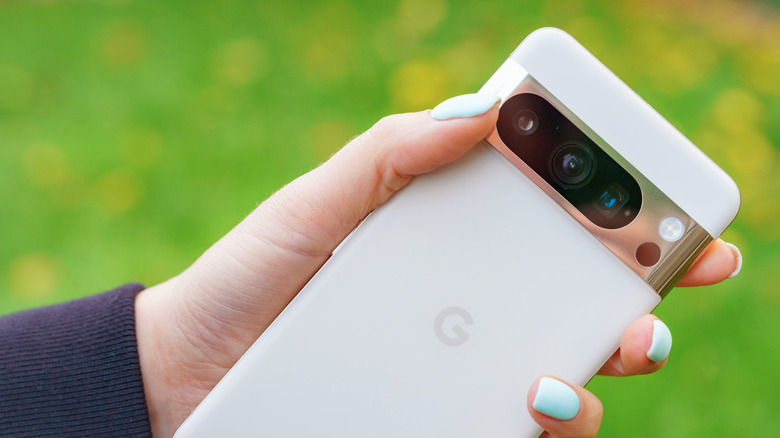 Hand holding a Pixel 8 Pro showing its rear