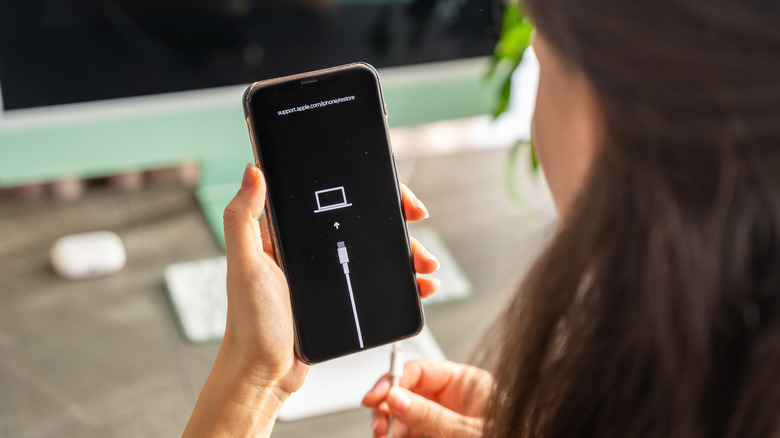 Connecting an iPhone to a Mac with a cable.